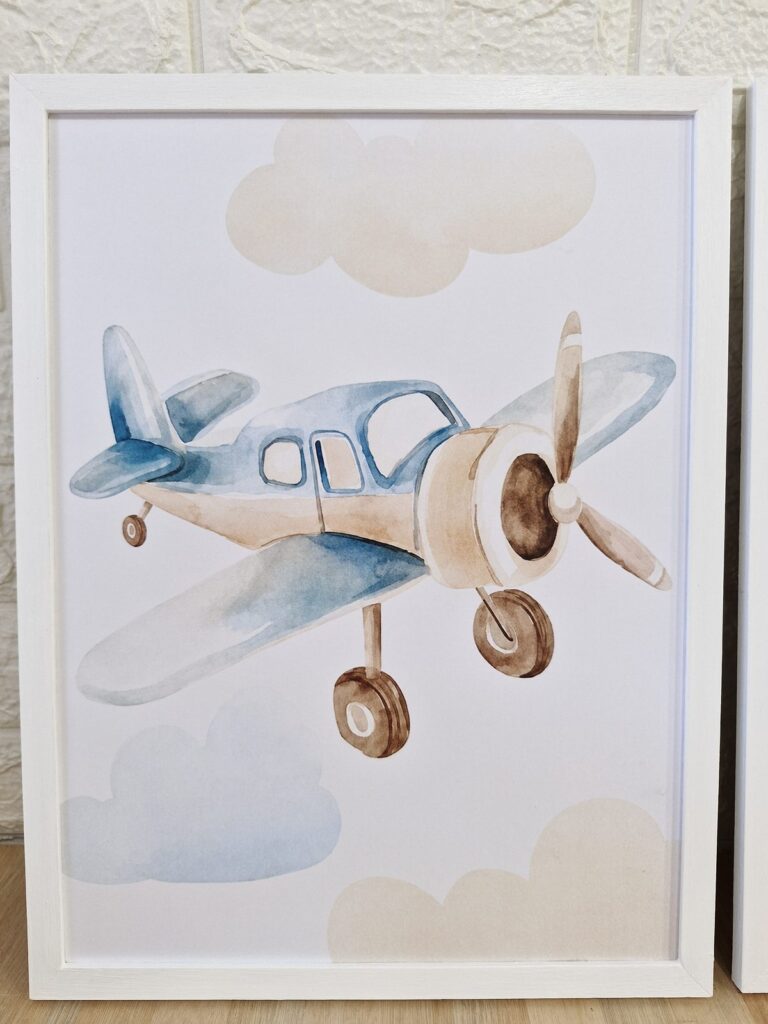 Avión antiguo entre nubes, en marco blanco. Trabajo realizado por Indokids, agosto de 2026.